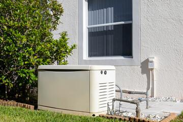 Professionally installed standby generator beside a home with natural gas piping and electrical conduit